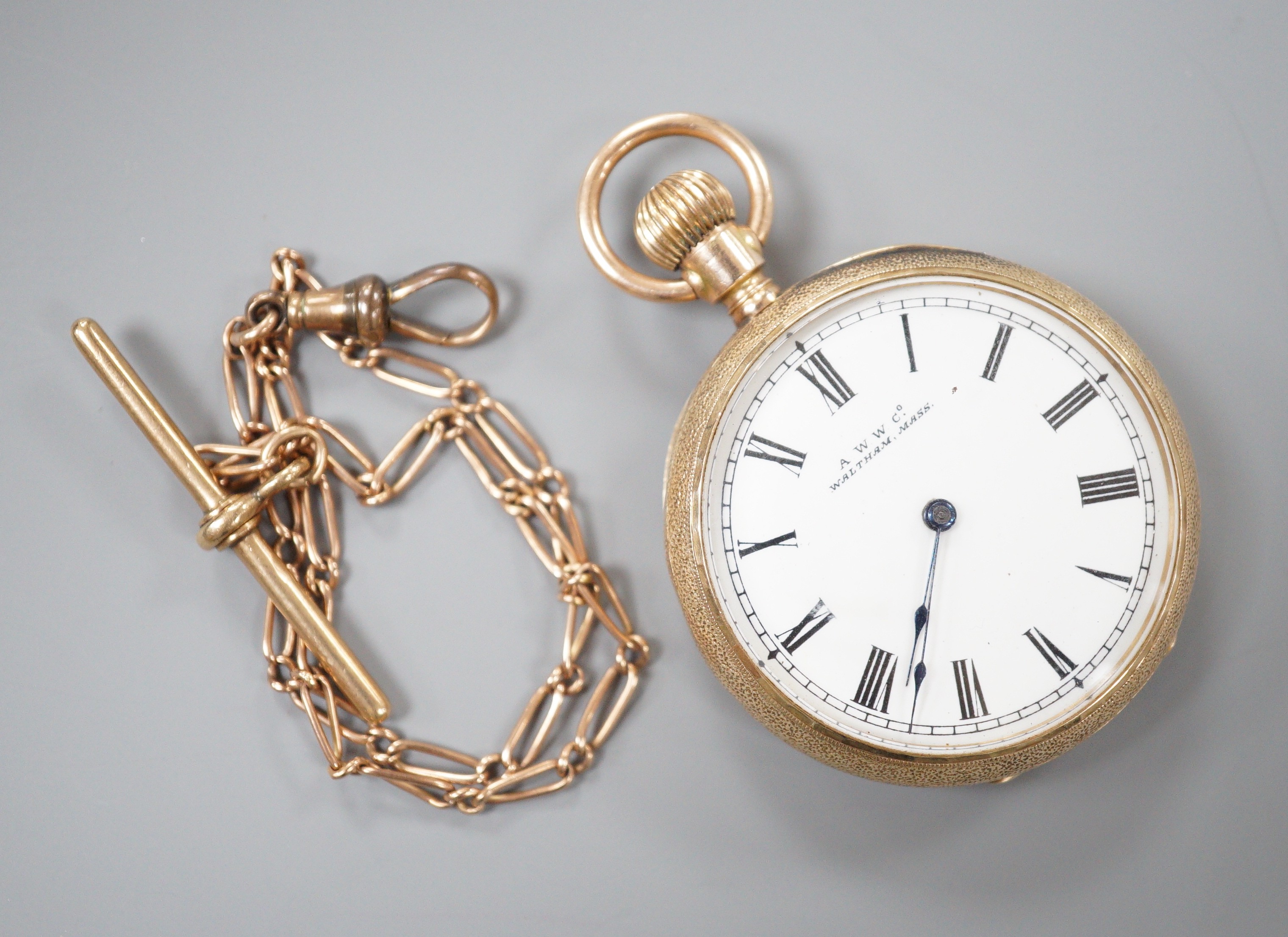 A gentleman’s 10C yellow metal Waltham open faced keyless pocket watch, gross 45.7 grams, on a 9ct gold albert, 6.3 grams.